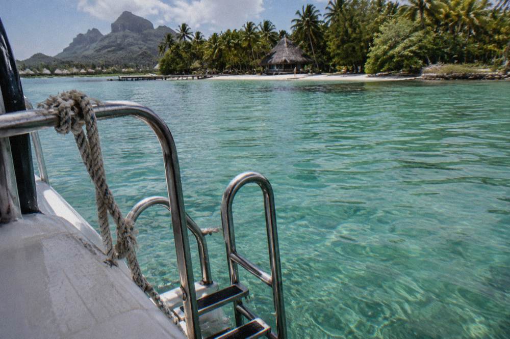 Boat ladder and rail at a calm lagoon snorkel stop