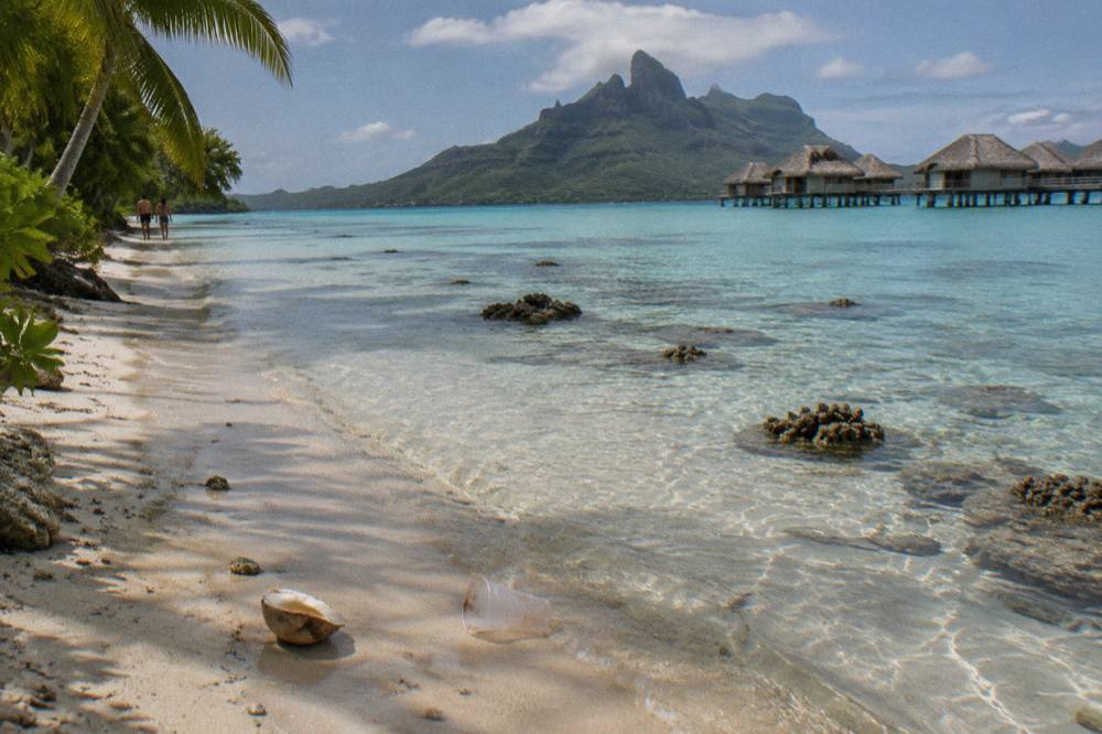Shallow calm lagoon water over a sandy bottom with scattered coral heads