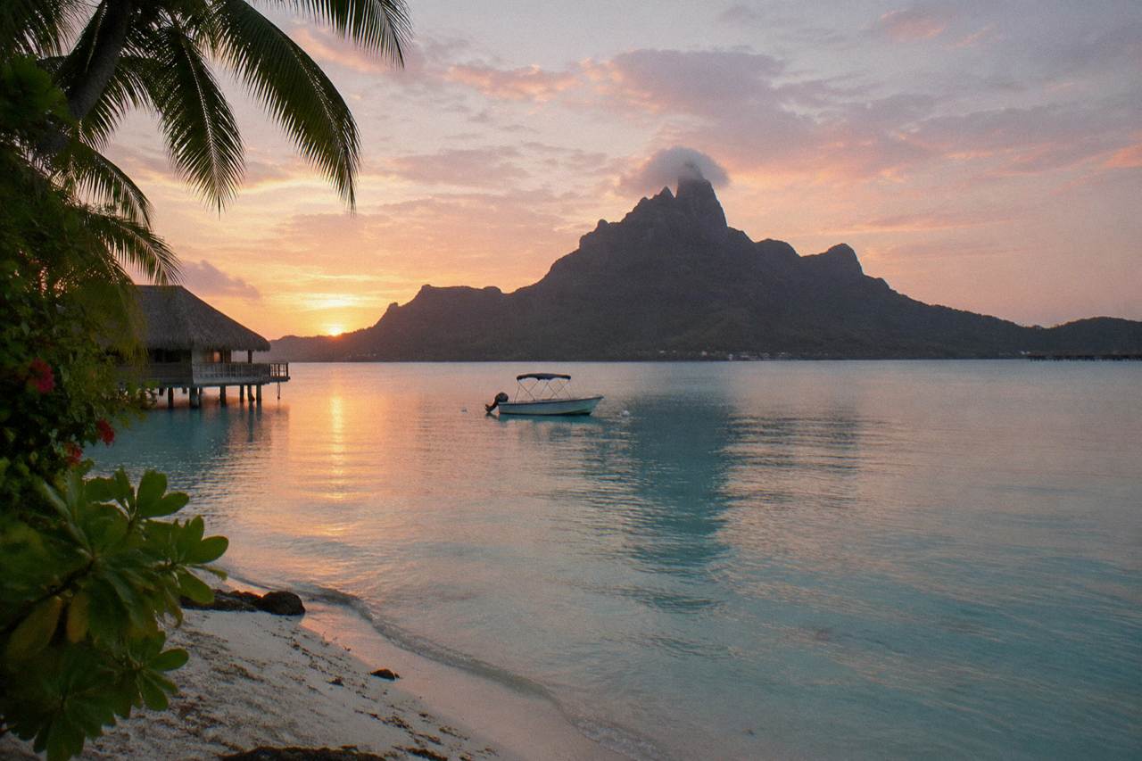 Calm turquoise lagoon water off Bora Bora with Mount Otemanu in the distance
